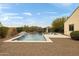 Backyard swimming pool has in-pool lounge chairs, a waterfall feature, and desert landscaping at 5448 E Windstone Trl, Cave Creek, AZ 85331