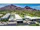 An aerial view showcases the community pool and resort-style amenities with mountain views at 5455 E Lincoln Dr # 3008, Paradise Valley, AZ 85253