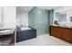 Modern bathroom with marble walls, soaking tub, and glass enclosed shower stall at 5455 E Lincoln Dr # 3008, Paradise Valley, AZ 85253