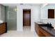 Elegant bathroom with double vanities, glass shower, and wood accents at 5455 E Lincoln Dr # 3008, Paradise Valley, AZ 85253