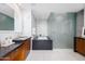 Modern bathroom featuring dual vanities, soaking tub, and glass enclosed shower at 5455 E Lincoln Dr # 3008, Paradise Valley, AZ 85253