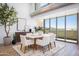 Bright dining area with modern furnishings and large windows, complemented by stylish decor and natural light at 5455 E Lincoln Dr # 3008, Paradise Valley, AZ 85253