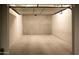 An empty attached garage with cement flooring is ready for the next homeowner's imagination at 5455 E Lincoln Dr # 3008, Paradise Valley, AZ 85253