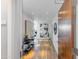 The hallway features light wood floors, white walls, recessed lighting and modern art at 5455 E Lincoln Dr # 3008, Paradise Valley, AZ 85253