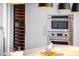 Wine fridge with stainless steel oven and microwave appliances in a modern kitchen at 5455 E Lincoln Dr # 3008, Paradise Valley, AZ 85253