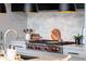 Stainless steel stovetop and marble backsplash in a modern kitchen setting at 5455 E Lincoln Dr # 3008, Paradise Valley, AZ 85253