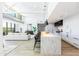 Bright, open-concept living room with a modern kitchen and a comfortable seating area with large windows at 5455 E Lincoln Dr # 3008, Paradise Valley, AZ 85253