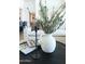 Bright living room decor with modern vase and reading material atop a round coffee table at 5455 E Lincoln Dr # 3008, Paradise Valley, AZ 85253