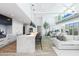 Spacious, light-filled living space featuring a modern kitchen island and open floor plan at 5455 E Lincoln Dr # 3008, Paradise Valley, AZ 85253