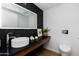Sleek powder room boasts a floating vanity, vessel sink, and chic black tile accent wall at 5455 E Lincoln Dr # 3008, Paradise Valley, AZ 85253