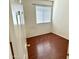 A bright bedroom with hard flooring and a view of the window with blinds at 592 E 9Th Ave, Apache Junction, AZ 85119