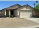 Beige single-story home with desert landscaping, featuring a two-car garage and a concrete driveway at 592 E 9Th Ave, Apache Junction, AZ 85119