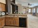 Kitchen featuring stainless steel sink and black dishwasher and an open view to the living area at 592 E 9Th Ave, Apache Junction, AZ 85119