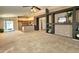 Spacious open-concept living room featuring neutral carpet, decorative shelving and a view of the kitchen at 592 E 9Th Ave, Apache Junction, AZ 85119