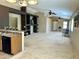 Open-concept living room featuring neutral carpet, decorative shelving and a view of the kitchen at 592 E 9Th Ave, Apache Junction, AZ 85119