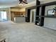 Spacious open-concept living room featuring neutral carpet, decorative shelving and a view of the kitchen at 592 E 9Th Ave, Apache Junction, AZ 85119