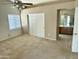 A main bedroom featuring a window, carpeted floors, closet and en-suite bathroom at 592 E 9Th Ave, Apache Junction, AZ 85119