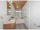 The bathroom features a vanity, jetted tub, wood-paneled ceiling, and floating shelves at 6025 W Marconi Ave, Glendale, AZ 85306
