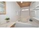 The bathroom features a vanity, jetted tub, wood-paneled ceiling, and floating shelves at 6025 W Marconi Ave, Glendale, AZ 85306