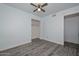 Bright bedroom features gray wood-look flooring, ceiling fan, and closet at 6025 W Marconi Ave, Glendale, AZ 85306