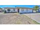 Inviting single-Gathering home featuring a well-manicured lawn and a spacious driveway at 6025 W Marconi Ave, Glendale, AZ 85306