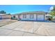 Well-kept home showcasing a large driveway, mature landscaping, and a welcoming facade at 6025 W Marconi Ave, Glendale, AZ 85306