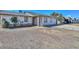Single-Gathering home with tan siding, a brick pillar, and an attached garage on a sunny day at 6025 W Marconi Ave, Glendale, AZ 85306