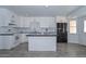 Modern kitchen featuring white cabinets, black countertops, and stainless steel appliances at 6025 W Marconi Ave, Glendale, AZ 85306