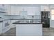 Updated kitchen with an island, granite countertops, white cabinets, and stainless steel appliances at 6025 W Marconi Ave, Glendale, AZ 85306