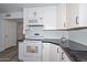 Updated kitchen featuring an island, granite countertops, white cabinets, and stainless steel appliances at 6025 W Marconi Ave, Glendale, AZ 85306