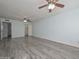 Spacious living room features gray wood-look flooring and access to the closet at 6025 W Marconi Ave, Glendale, AZ 85306