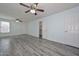 Bright living room boasts gray wood-look flooring, and access to the bathroom and hall at 6025 W Marconi Ave, Glendale, AZ 85306