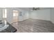 Spacious living room with gray wood-look flooring and access to the patio at 6025 W Marconi Ave, Glendale, AZ 85306