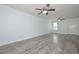 Bright living room features gray wood-look flooring and dual ceiling fans at 6025 W Marconi Ave, Glendale, AZ 85306