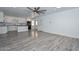 Open-plan living and kitchen area with modern gray floors, white cabinets, and bright, neutral walls at 6025 W Marconi Ave, Glendale, AZ 85306