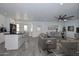Open-concept living space with island seating, dining area, and comfortable furniture at 6025 W Marconi Ave, Glendale, AZ 85306