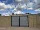 Backyard featuring a large steel gate in a brick wall for enhanced security and privacy at 6201 W Acoma Dr, Glendale, AZ 85306
