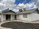 View of the backyard with a covered patio, AC unit, solar panels, and fenced perimeter at 6201 W Acoma Dr, Glendale, AZ 85306