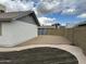 Backyard features a fenced perimeter and a gravel area with stepping stones at 6201 W Acoma Dr, Glendale, AZ 85306