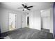 Bedroom featuring updated carpet, ceiling fan, and an ensuite bathroom at 6201 W Acoma Dr, Glendale, AZ 85306