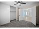 Bedroom featuring plush carpet, a ceiling fan, and ample closet space at 6201 W Acoma Dr, Glendale, AZ 85306