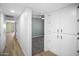 Hallway featuring neutral colors, updated flooring, and access to the bedrooms at 6201 W Acoma Dr, Glendale, AZ 85306
