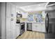 Beautifully updated kitchen features white cabinets, quartz countertops, and stainless steel appliances at 6201 W Acoma Dr, Glendale, AZ 85306