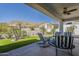 This backyard features a covered patio with ceiling fan, desert landscaping, and views of nearby hills at 6334 E Viewmont Dr # 29, Mesa, AZ 85215