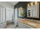 Bathroom featuring double sinks, decorative mirrors, and shower with glass block at 6334 E Viewmont Dr # 29, Mesa, AZ 85215