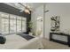 Bright bedroom features a ceiling fan, white plantation shutters, and ensuite bathroom with glass block window at 6334 E Viewmont Dr # 29, Mesa, AZ 85215