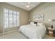 Cozy bedroom boasts neutral decor, a large window and ceiling fan for added comfort at 6334 E Viewmont Dr # 29, Mesa, AZ 85215