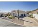 This home features a circular driveway, desert landscaping, and a tile roof at 6334 E Viewmont Dr # 29, Mesa, AZ 85215