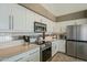 Bright kitchen with stainless steel appliances, white cabinets, and a metallic backsplash at 6334 E Viewmont Dr # 29, Mesa, AZ 85215