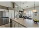 Bright kitchen featuring a large island with a double sink, stainless steel appliances, and an open dining area at 6334 E Viewmont Dr # 29, Mesa, AZ 85215